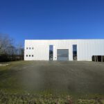 Außenansicht einer modernen Gewerbehalle mit großer befestigter Hoffläche zur Vermietung